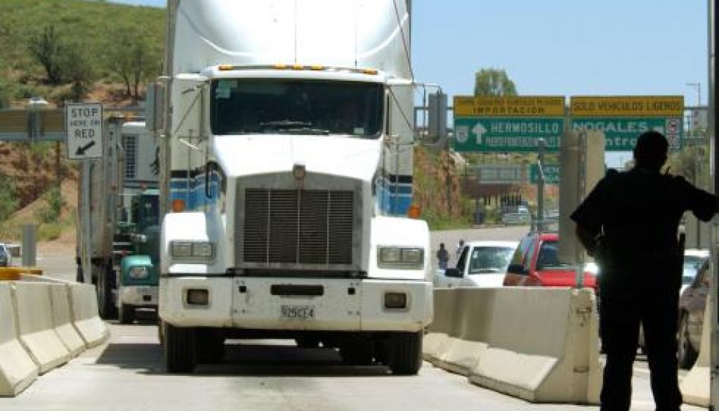 A United States Customs agent waits for a northbound truck crossing the border to enter the United States from Nogales, Mexico.