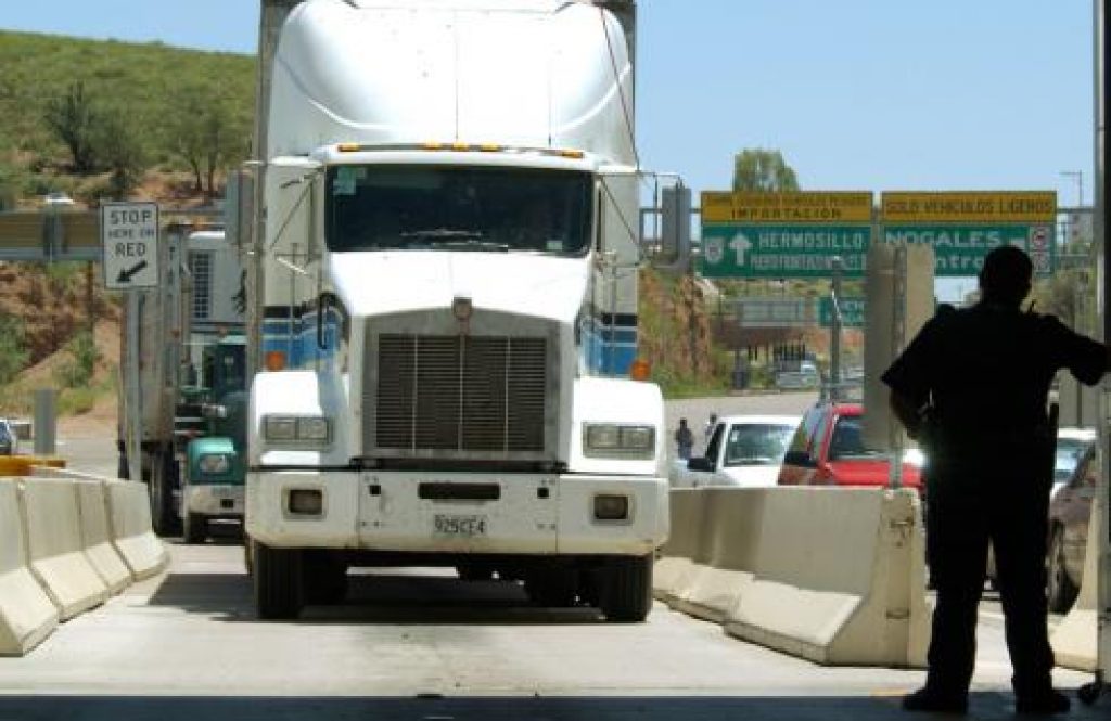 A United States Customs agent waits for a northbound truck crossing the border to enter the United States from Nogales, Mexico.