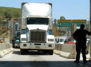 A United States Customs agent waits for a northbound truck crossing the border to enter the United States from Nogales, Mexico.